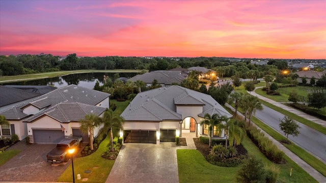 aerial view at dusk with a water view