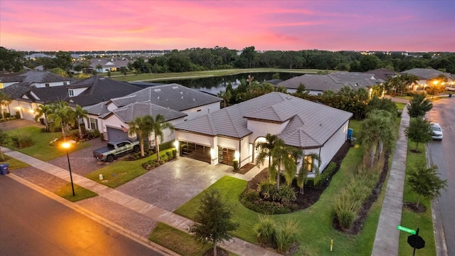 aerial view at dusk with a water view