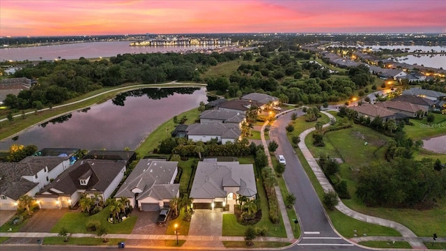 aerial view at dusk with a water view