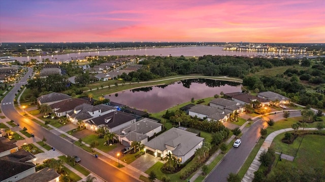 aerial view at dusk with a water view