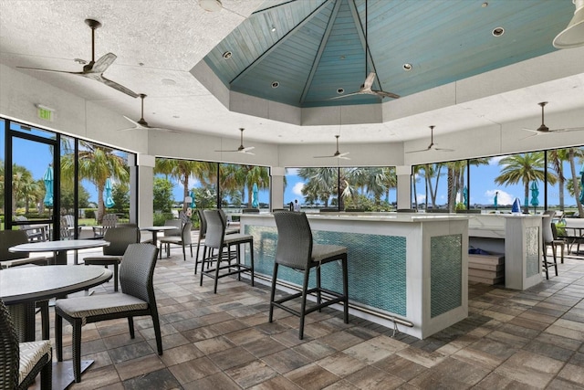 kitchen featuring ceiling fan and a towering ceiling