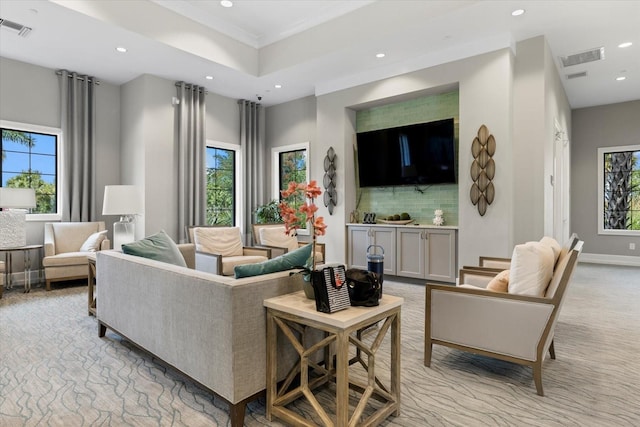 living room with a healthy amount of sunlight and light colored carpet