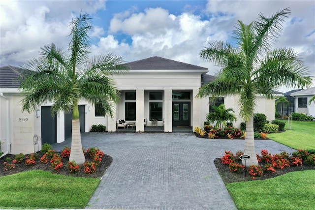 view of front of home featuring french doors and a front lawn