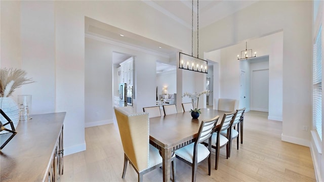 dining area with an inviting chandelier and light wood-type flooring