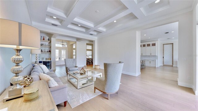 living room with french doors, coffered ceiling, wine cooler, light wood-type flooring, and beam ceiling