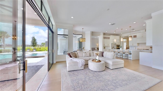 living room with light hardwood / wood-style floors and an inviting chandelier