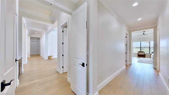 hallway with light hardwood / wood-style flooring and ornamental molding