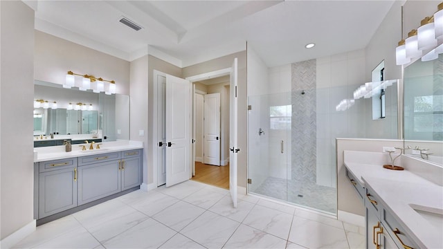 bathroom with a shower with door and vanity