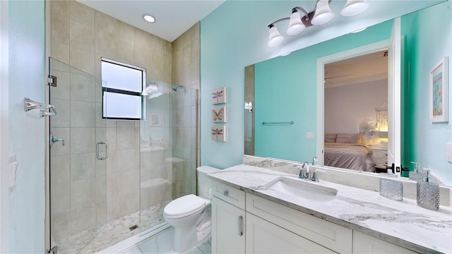 bathroom featuring vanity, toilet, and a shower with door