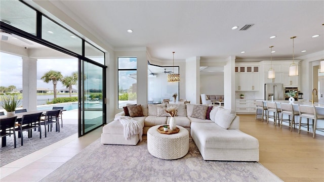 living room featuring light hardwood / wood-style flooring and ornamental molding