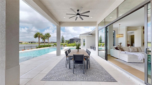 view of swimming pool featuring outdoor lounge area, ceiling fan, and a patio