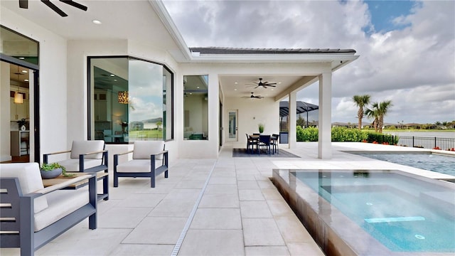 view of pool with an in ground hot tub, ceiling fan, and a patio