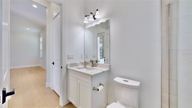 bathroom featuring vanity, hardwood / wood-style flooring, and toilet