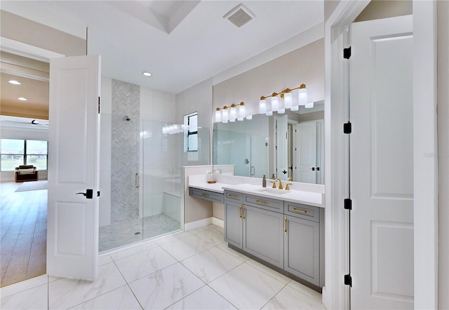 bathroom with vanity and a shower with door