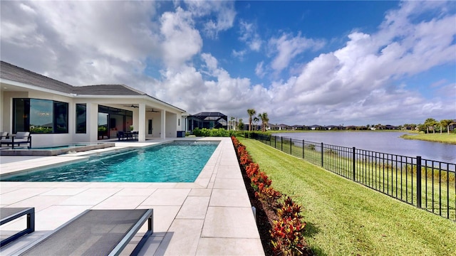 view of swimming pool featuring ceiling fan, a patio area, a water view, and a yard