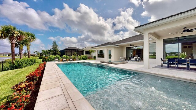 view of swimming pool featuring ceiling fan and a patio