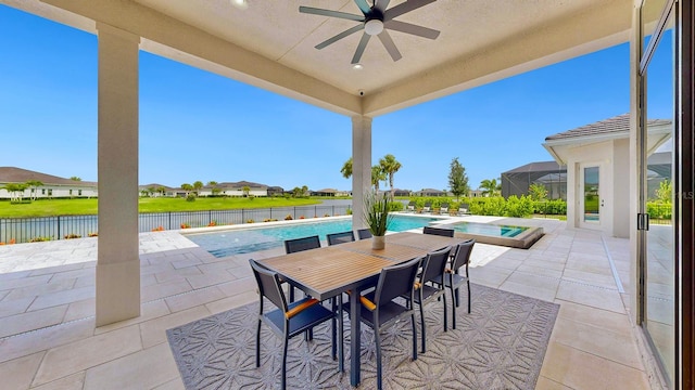 view of patio / terrace with ceiling fan, a pool with hot tub, and a water view