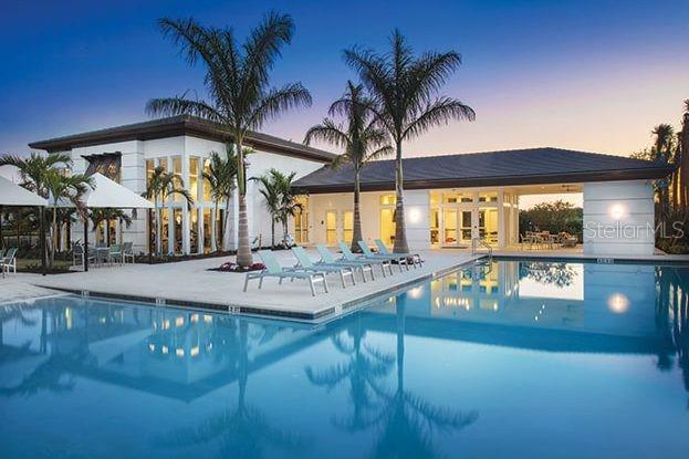 pool at dusk featuring a patio area