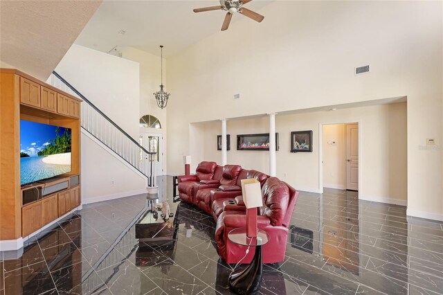 living room featuring ceiling fan and a high ceiling