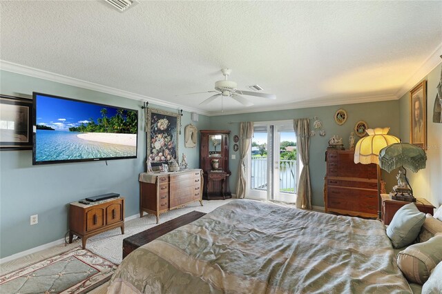 bedroom featuring ornamental molding, access to exterior, and a textured ceiling