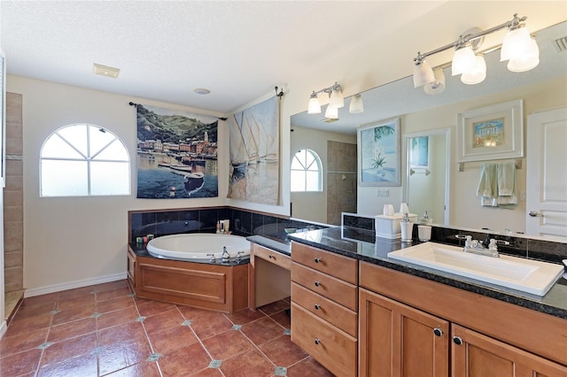 bathroom featuring tile patterned flooring, vanity, independent shower and bath, and a textured ceiling