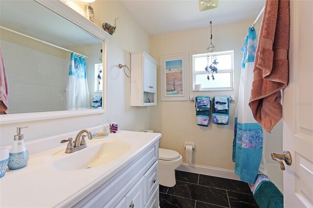 bathroom featuring vanity and toilet