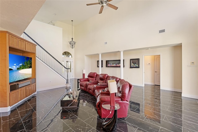 8607 51st Ave W, Bradenton, FL 34210 - living room with a high ceiling, marble tiled floors, a ceiling fan, stairs, and baseboards