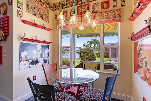8607 51st Ave W, Bradenton, FL 34210 - dining room featuring baseboards, plenty of natural light, and a water view