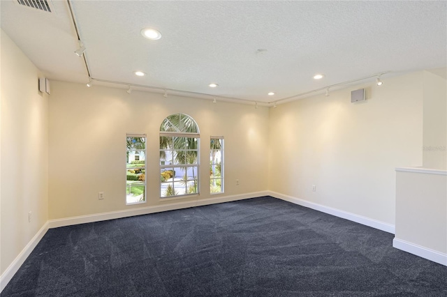 8607 51st Ave W, Bradenton, FL 34210 - empty room with track lighting, dark colored carpet, recessed lighting, and baseboards