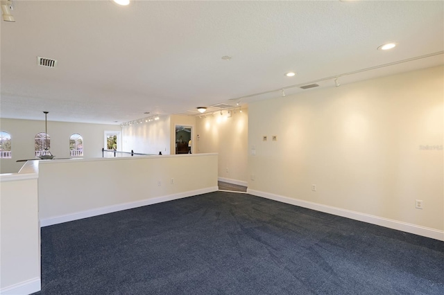 8607 51st Ave W, Bradenton, FL 34210 - spare room with dark colored carpet, baseboards, and recessed lighting