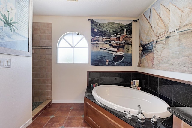 8607 51st Ave W, Bradenton, FL 34210 - bathroom with a bath, baseboards, and tile patterned flooring