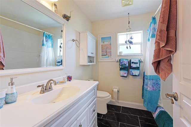8607 51st Ave W, Bradenton, FL 34210 - full bath featuring marble look tile flooring, toilet, vanity, baseboards, and curtained shower