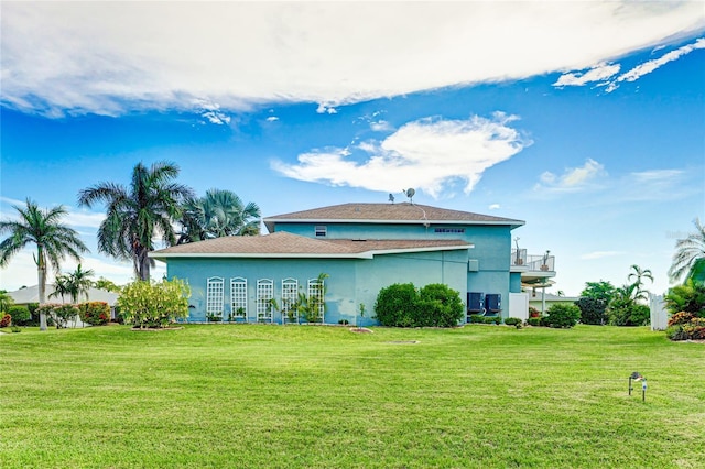 8607 51st Ave W, Bradenton, FL 34210 - view of home's exterior with a yard, stucco siding, and a balcony