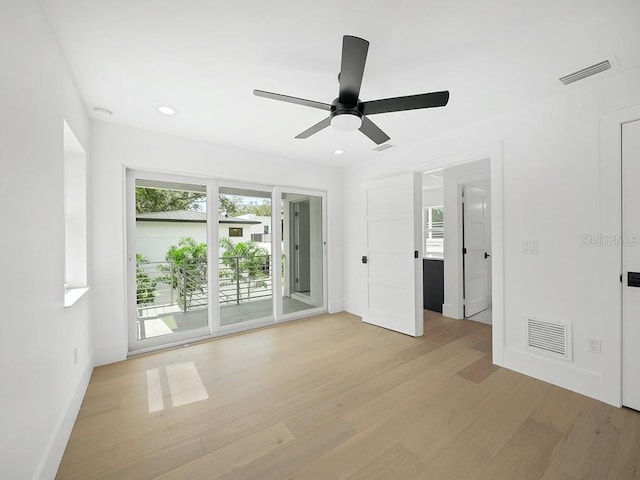 spare room with light hardwood / wood-style flooring and ceiling fan