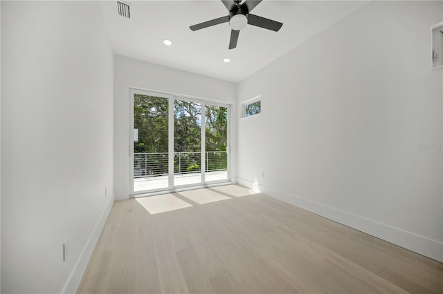 spare room with ceiling fan and light wood-type flooring