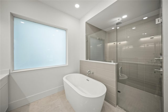 bathroom with tile patterned flooring and separate shower and tub