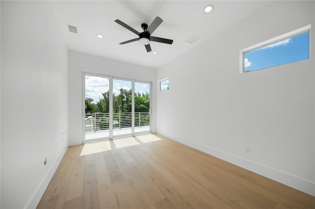 spare room with ceiling fan, a healthy amount of sunlight, and light wood-type flooring