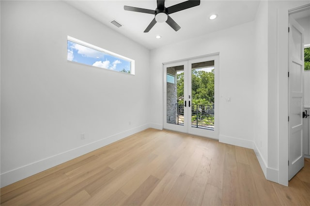 empty room featuring ceiling fan, french doors, and light hardwood / wood-style flooring