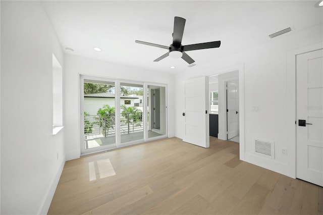 interior space featuring access to outside, light hardwood / wood-style floors, and ceiling fan