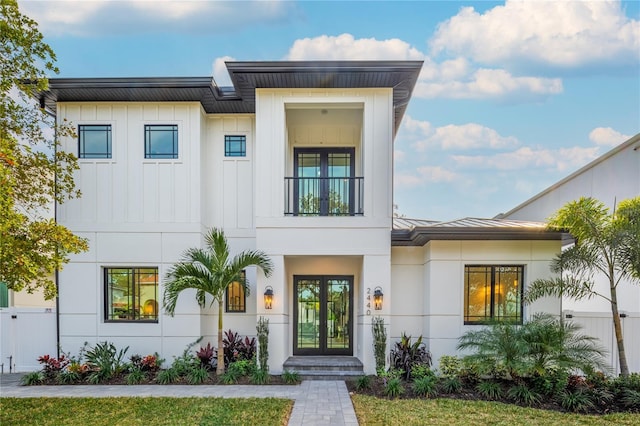 2440 Floyd St, Sarasota, FL 34239 - view of front facade featuring french doors, stucco siding, and a balcony