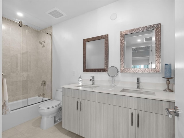 full bathroom featuring tile patterned floors, vanity, bath / shower combo with glass door, and toilet