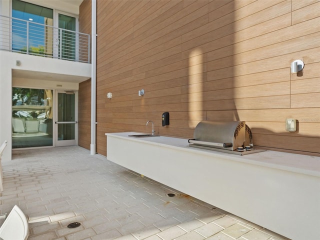 bathroom with wooden walls and sink