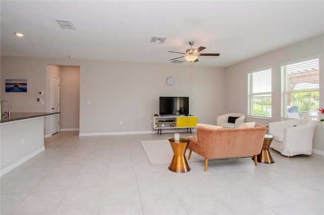 tiled living room featuring ceiling fan