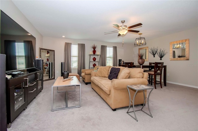 carpeted living room featuring ceiling fan