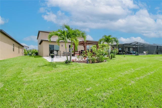 rear view of property with a patio area, a yard, and a pergola