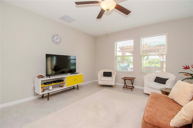 tiled living room with ceiling fan