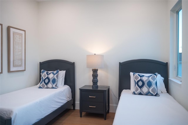 bedroom with dark hardwood / wood-style flooring