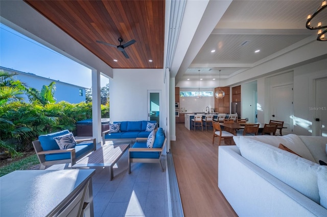 view of patio with ceiling fan, outdoor lounge area, and sink