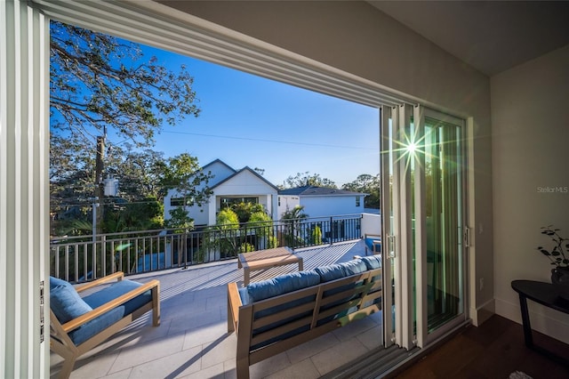 view of patio with an outdoor hangout area and a balcony