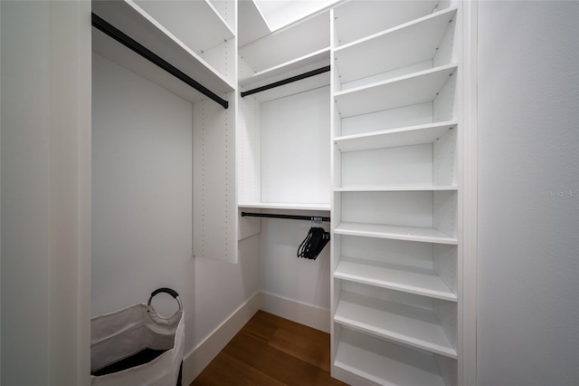 walk in closet featuring dark hardwood / wood-style floors